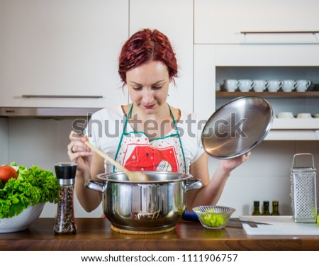 A girl in the kitchen, preparing lunch, salt, pepper, healthy food, vegetables, salad, girl preparing a meal in the kitchen