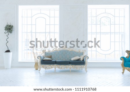 Luxury light interior of living room with gold wall and chic expensive furniture in white and gold colors Royalty-Free Stock Photo #1111910768