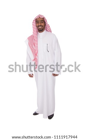 Full-length shot of a khaleeji man wearing a thobe, standing and smiling, isolated on white background