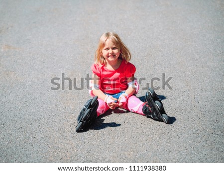 happy little girl on roller skates outside