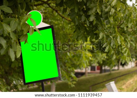 Advertisemtn sign in trees with greenscreen