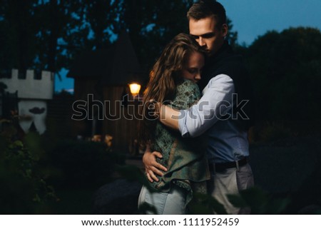 Cosy beautiful happy couple evening hug together