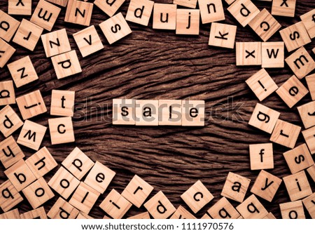 Sale word written cube on wooden background. Vintage concept.