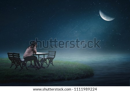 The girl sat on the back of a lonely heart on a chair in the moon creaking on a beautiful grass island.