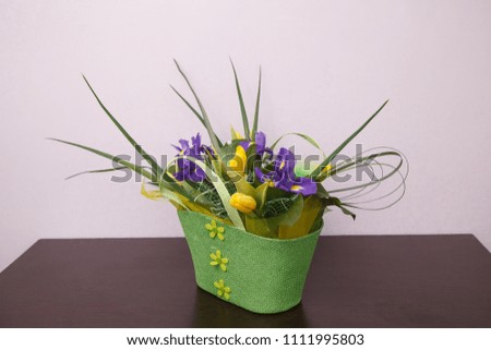Yellow tulips and irises bouquet  in a basket. Spring flowers bouquet. Mother's day card. Women's day congratulations. 8 March background. Happy birthday background.