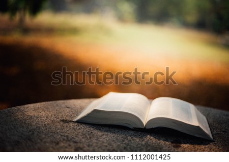 The opened Holy Bible is on the table.  Royalty-Free Stock Photo #1112001425