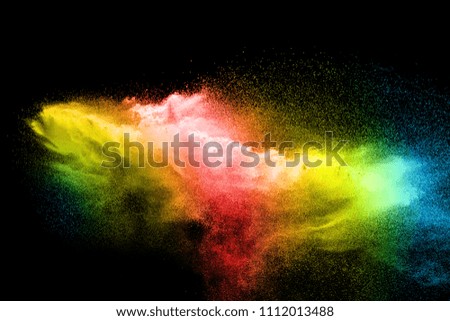 Multicolored particles explosion on black background.
