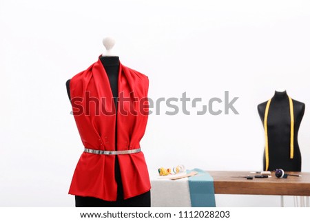 Mannequin with red cloth in tailor studio