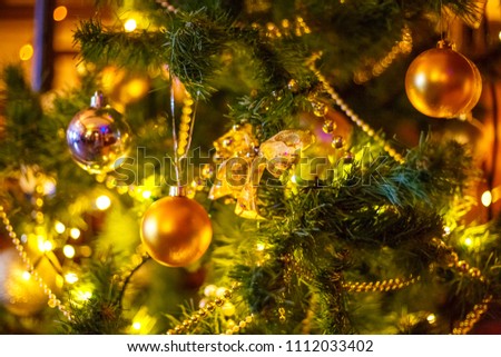Christmas tree decorated with toys and garland closeup