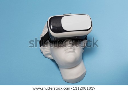 Virtual reality headset on white gypsum Aphrodite face sculpture, VR goggles