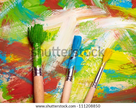 Paintbrushes on abstract grange background
