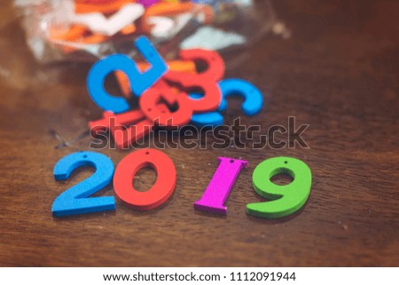 colorful wooden numbers forming the number 2019 and in plastic bag, For the new year 2019
