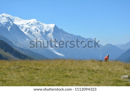 Man sitting with view of Alpes valley and Mont Blanc. 