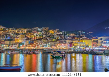Amazing cityscape view of Parga city, Greece during the Summer. Long exposure HDR photography with beautiful architectural colorful buildings illuminated at night near the port of Parga Epirus, Greece