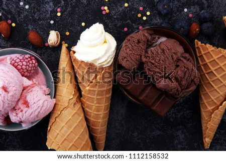 Vanilla frozen yogurt or soft ice cream in waffle cone in various flavour and strawberry icecream