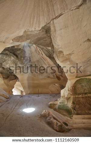 Bell Cave located at Beit Govrin, Israel. Photo taken from inside, with ray of light falling from above.