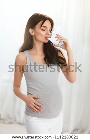Drink Water. Pregnant Woman Drinking Water From Glass