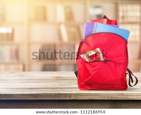 Red backpack with school supplies