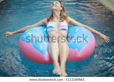 inflatable pool girl hotel girl / rest in a luxury hotel,  beautiful girl in  pool with an inflatable