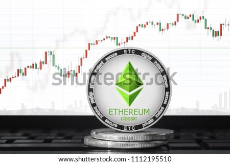 Ethereum Classic (ETC) cryptocurrency; ethereum classic coin on the background of the chart Royalty-Free Stock Photo #1112195510