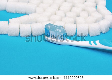 Toothbrush with pasta on sugar background.