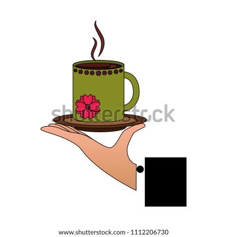 hand holding decorative flower hot coffee cup on dish