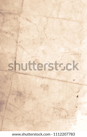 Blank aged paper sheet as old dirty frame background with dust and stains. Front view. Vintage and antique art concept. Detailed closeup studio shot. 