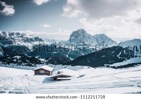 Odle mountain range, Seceda peak between clouds in winter , Val Gardena in Dolomites at Italy