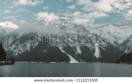
Plansee lake in Austria mountains with snow, ice hockey, Tirol 