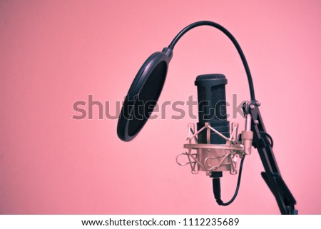 Condenser Microphone with holder and jack connected in pink background and copy space on right of picture Royalty-Free Stock Photo #1112235689