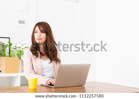 Beautiful young asian businesswoman using laptop