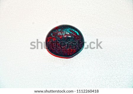  decorative stone black with red streaks interspersed with shiny sea sphere on white background