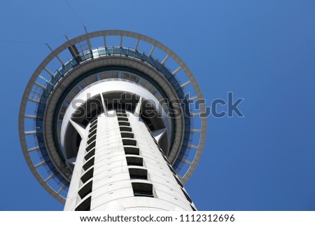 looking up at Auckland's sky tower from the street on a beautiful day Royalty-Free Stock Photo #1112312696