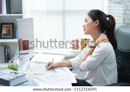 Asian women Aches from working She felt like relaxing Royalty-Free Stock Photo #1112316041