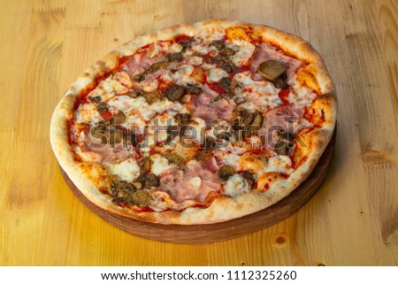 Pizza with ham and pickled cucumbers