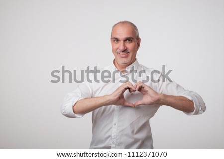 old european man making out of hands heart. Doing charity work, take care of health or being in love concept