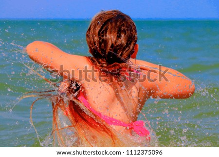 A teenage girl loves to swim in the sea.