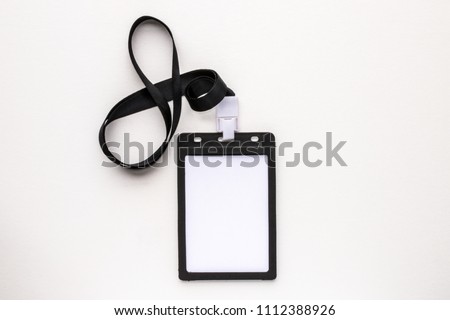 Top view close up of blank white badge name tag isolated on white background. Flat lay creative view. Business office background view.