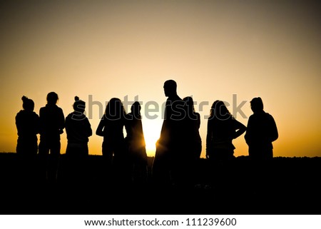 an image of a group of people at sunset