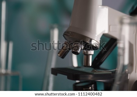 Science laboratory research and development concept. microscope with test tubes