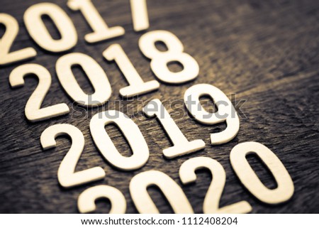2019 in running year numbers on wood background Royalty-Free Stock Photo #1112408204