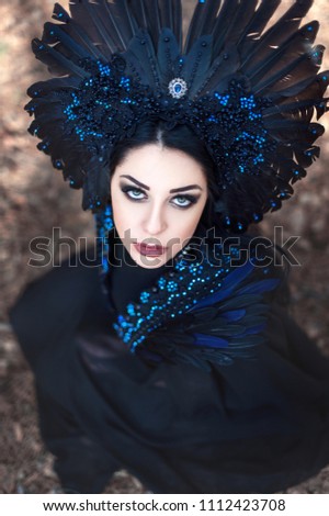 Portrait of a beautiful mysterious woman in the forest.