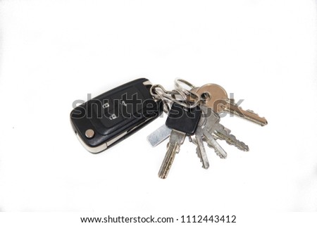 A bunch of keys on a white background. Keys from the car, the keys to the apartment. Royalty-Free Stock Photo #1112443412