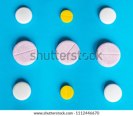 Different pills on the blue background, health care concept. 