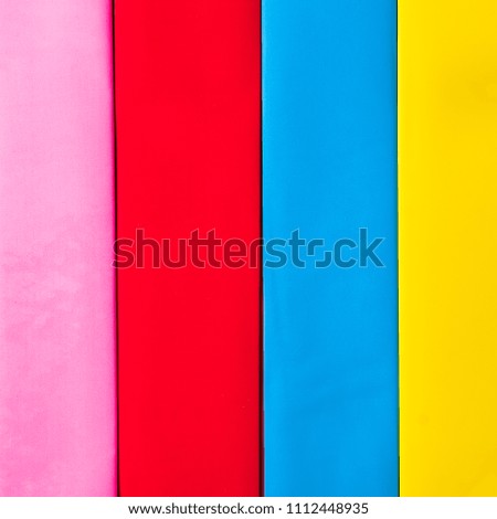 Multi colored abstract paper of pastel colors; with geometric shape; flat lay.