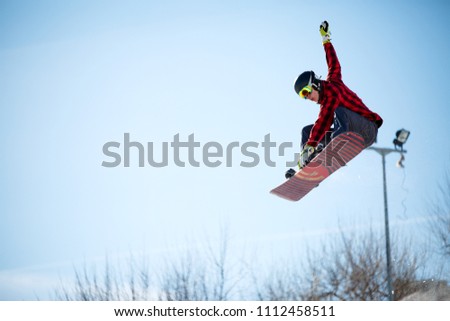 Photo of young athlete jumping with snowboard