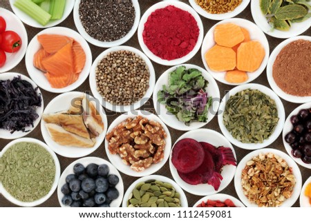 Health food to benefit brain cognitive functions with fish, fruit, vegetables, seeds, nuts, supplement powders with herbs also used in herbal medicine.
 Royalty-Free Stock Photo #1112459081