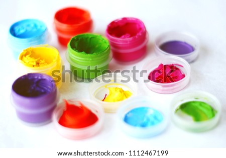 cans with multi-colored paints for drawing. yellow, green, red, purple, blue, orange. blurred white background Royalty-Free Stock Photo #1112467199