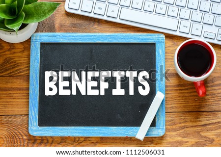 BENEFITS handwritten with white chalk on a blackboard on wood background Royalty-Free Stock Photo #1112506031