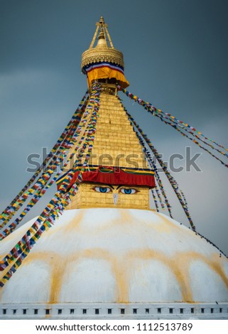 Boudhanath stupa in Kathmandu, Nepal. Stormy clouds in the background.